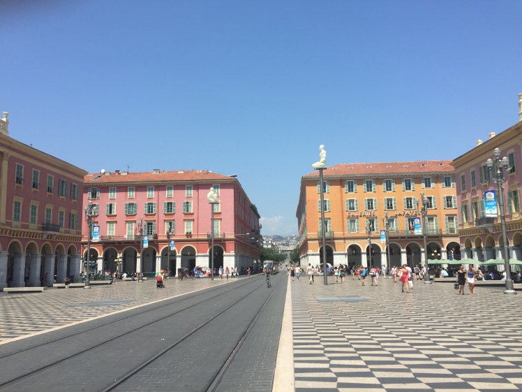 Place Massena. Photo taken about a week ago. We were by one of the pillars in a crowd, when people started running from the promenade, spilling into the square.